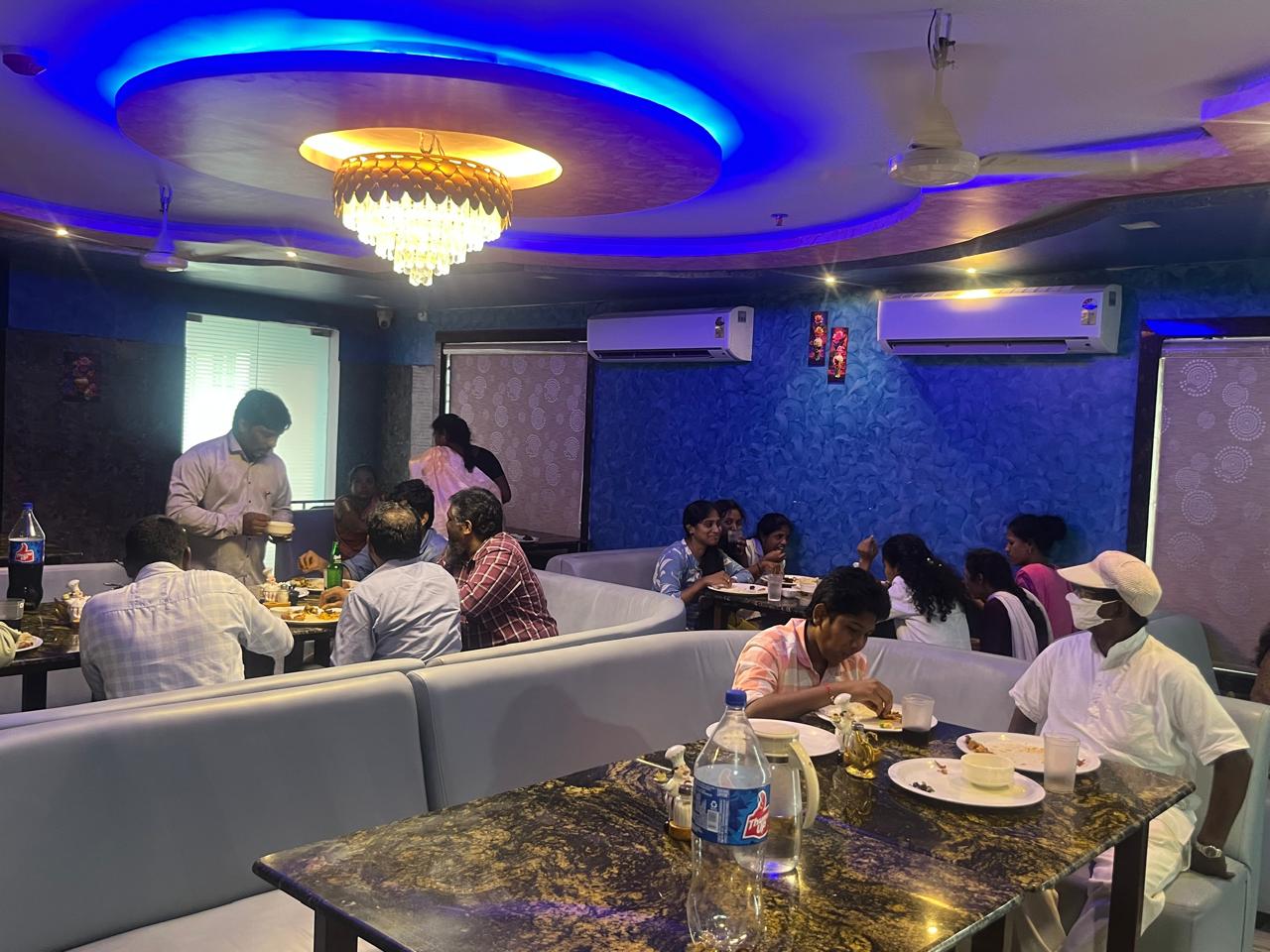 Guests dining in the royal blue air-conditioned hall at Lotus Grand